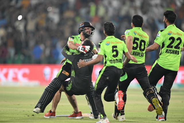 Lahore Qalanders' Sikandar Raza (L) celebrates with teammates their victory at the end of the Pakistan  Super League (PSL) Twenty20 final cricket match between Lahore Qalandars and Quetta Gladiators at the Gaddafi Stadium in Lahore on May 25, 2025. (Photo by Aamir QURESHI / AFP)