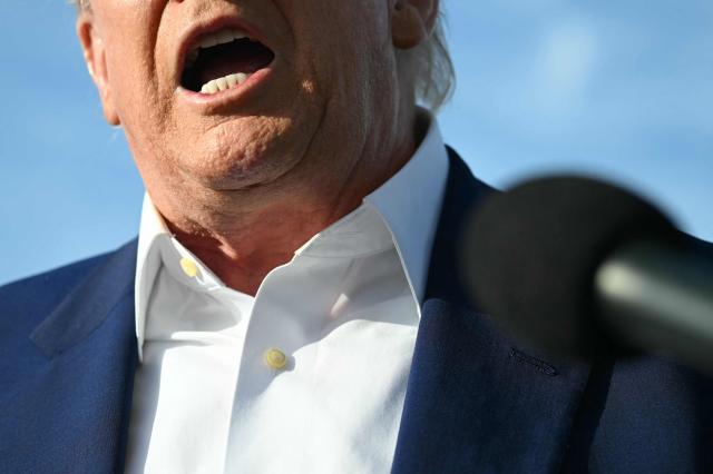 US President Donald Trump speaks to journalists before boarding Air Force One prior to departure from Morristown Municipal Airport in Morristown, New Jersey, May 25, 2025, after spending the weekend in New Jersey. (Photo by SAUL LOEB / AFP)