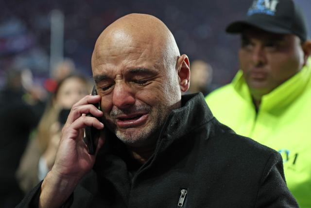 Platense's coach Favio Orsi cries as he talks on the phone after winning the Argentine Professional Football League 2025 Apertura Tournament semi-final match between San Lorenzo and Platense at the Pedro Bidegain stadium in Buenos Aires on May 25, 2025. (Photo by ALEJANDRO PAGNI / AFP)