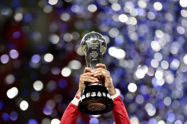 TOPSHOT - Toluca's forward #09 Alexis Vega lifts the trophy with teammates during a ceremony for the Mexican Champions following the Liga MX Clausura football tournament second leg final between Toluca and America at the Nemesio Diez stadium in Toluca de Lerdo, state of Mexico, Mexico on May 25, 2025. (Photo by Rodrigo Oropeza / AFP)