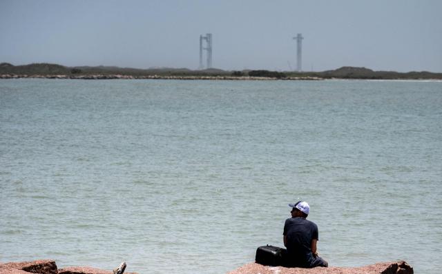 The SpaceX Starship rocket stands on the launchpad ahead of its scheduled launch from the SpaceX Starbase in Boca Chica as seen from South Padre Island, Texas on May 27, 2025. SpaceX said on My 23 it will make another launch attempt next week of the massive Starship rocket -- key to CEO Elon Musk's long-term vision of colonizing Mars -- after two consecutive in-flight explosions earlier this year. "The ninth flight test of Starship is preparing to launch as soon as Tuesday, May 27," the company said on its website, adding the launch window would open at 6:30 pm (2330 GMT) at its base in Texas. (Photo by Sergio FLORES / AFP)