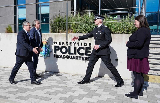 Britain's Prime Minister Keir Starmer meets with Police and Crime Commissioner Emily Spurrell (R), Deputy Chief Constable Chris Green (2R) and the Mayor of Liverpool City Region, Steve Rotheram (2L) during a visit to Merseyside Police Headquarters in Liverpool, north-west England on May 28, 2025, following the incident where a man drove a car into crowds that had gathered on May 26 to watch an open-top bus parade for Liverpool's Premier League trophy celebrations. UK police were given more time Wednesday to question a man suspected of driving while on drugs into crowds celebrating Liverpool's Premier League win, as seven people remained in hospital. (Photo by Peter Byrne / POOL / AFP)