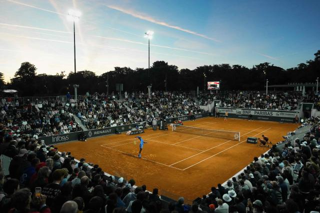 Spectators watch US Frances Tiafoe (L) serving to Spain's Pablo Carreno Busta during their men's singles match on day 4 of the French Open tennis tournament at the Roland-Garros Complex in Paris on May 28, 2025. (Photo by Dimitar DILKOFF / AFP)