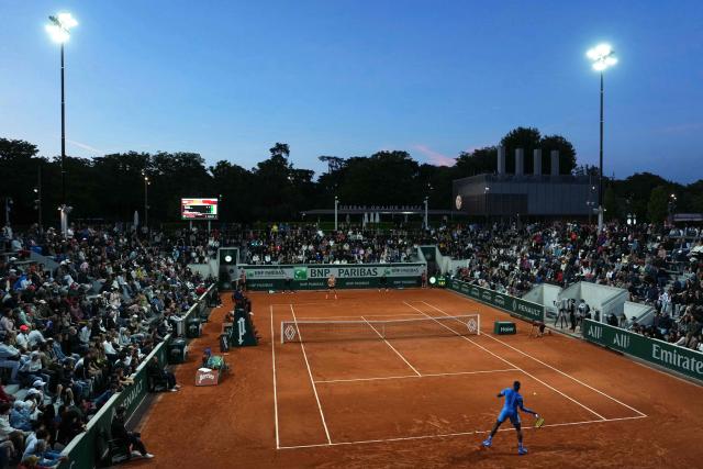 US Frances Tiafoe (front) plays a forehand return to Spain's Pablo Carreno Busta during their men's singles match on day 4 of the French Open tennis tournament at the Roland-Garros Complex in Paris on May 28, 2025. (Photo by Dimitar DILKOFF / AFP)