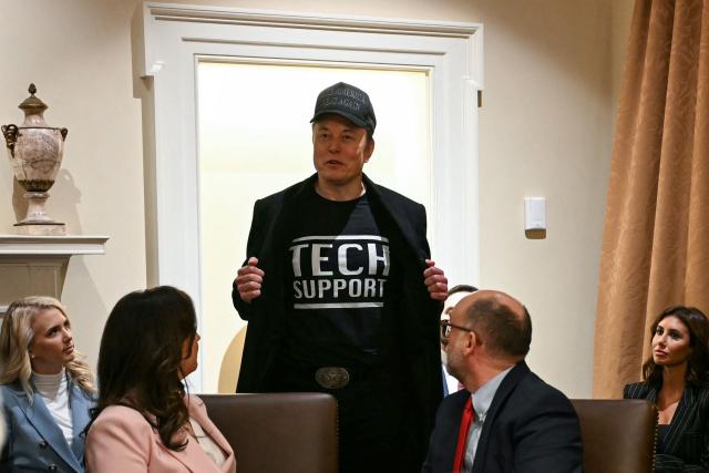 (FILES) Leader of the Department of Government Efficiency Elon Musk wears a shirt that says "Tech Support" as he speaks during a cabinet meeting with US President Donald Trump at the White House in Washington, DC, on February 26, 2025. Billionaire Elon Musk on May 28, 2025 said he was leaving his position within the US government after leading the so-called Department of Government Efficiency in a controversial effort to slash federal spending. "As my scheduled time as a Special Government Employee comes to an end, I would like to thank President Donald Trump for the opportunity to reduce wasteful spending," he wrote on his social media platform X. (Photo by Jim WATSON / AFP)