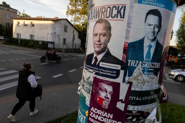 (FILES) Electoral posters of Warsaw's mayor and member of Polands ruling Civic Coalition party Rafal Trzaskowski (R), Karol Nawrocki (L) - candidate for the 2025 Polish presidential election supported by Poland's right-wing Law and Justice (PiS) party and left wing candidate Adrian Zandberg are seen on the street of Warsaw on May 6, 2025. A large water park has pride of place in the heart of Polish village Kleszczow -- an apparent sign of the prosperity of the area known as "the Polish Kuwait". But residents worry these riches will come to an end. That was a chief concern when they overwhelmingly voted for the far-right in round one of the presidential election this month. The far-right is now playing kingmaker ahead of the June 1 runoff, which will pit pro-EU Warsaw mayor Rafal Trzaskowski against nationalist historian Karol Nawrocki. (Photo by Wojtek RADWANSKI / AFP)