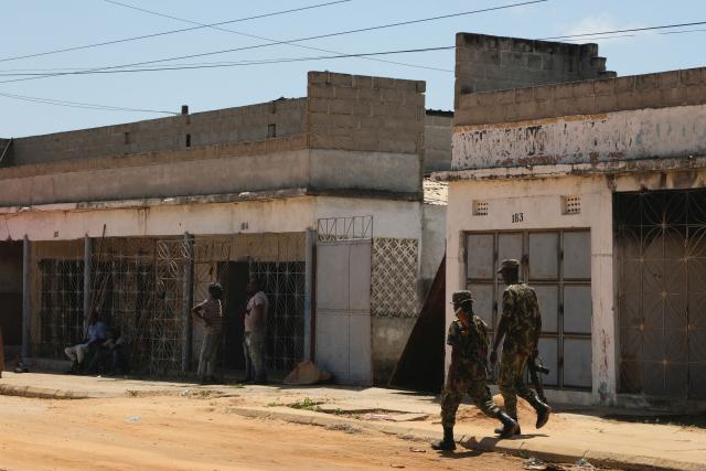 (FILES) Mozambican soldiers walk in a street of Mocímboa da Praia, in the Cabo Delgado province, Mozambique, on September 27 2022. A series of attacks in northern Mozambique this month point to a resurgence of violence by Islamic State-linked militants as energy giant TotalEnergies prepares to resume a major gas project, analysts say.
The group terrorised northern Mozambique for years before brazenly vowing in 2020 to turn the northern gas-rich Cabo Delgado province into a caliphate. (Photo by Camille LAFFONT / AFP)