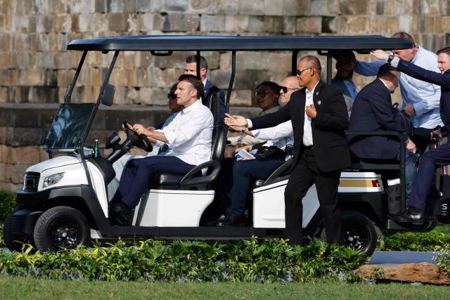 France's President Emmanuel Macron (L) drives a cart alongside his wife Brigitte Macron during a visit at Borobudur Temple, the world’s largest Buddhist monument and a UNESCO World Heritage Site, in Magelang, Central Java, on May 29, 2025. (Photo by Ludovic MARIN / POOL / AFP)