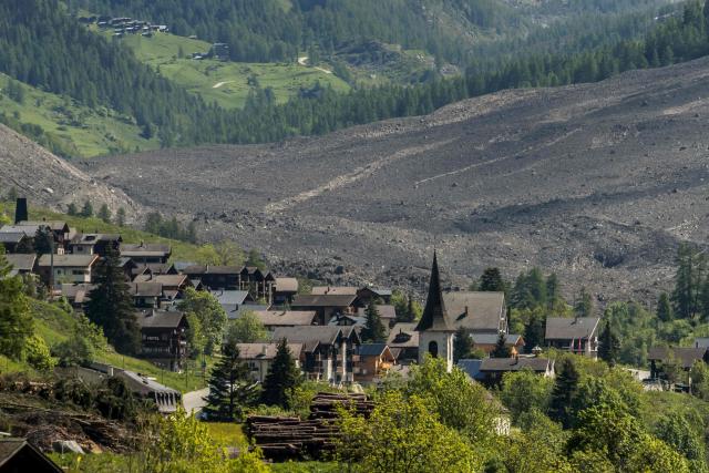 This photograph taken from Ferden shows a huge landslide next to the village of Wiler, on May 29, 2025, the day after the Birch Glacier collapsed and partially destroyed the small village of Blatten in the Swiss Alps. A massive glacier collapse on May 28, 2025 in southern Switzerland partially destroyed the small village of Blatten, which had been completely evacuated last week due to the impending danger, officials said. Around 3:30 pm (1330 GMT) a huge collapse occurred on the Birch Glacier, emergency services in the Wallis region said. (Photo by FABRICE COFFRINI / AFP)