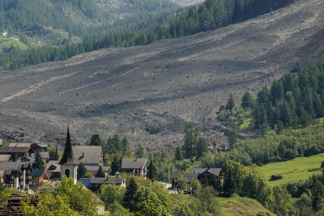 This photograph taken from Ferden shows a huge landslide next to the village of Wiler, on May 29, 2025, the day after the Birch Glacier collapsed and partially destroyed the small village of Blatten in the Swiss Alps. A massive glacier collapse on May 28, 2025 in southern Switzerland partially destroyed the small village of Blatten, which had been completely evacuated last week due to the impending danger, officials said. Around 3:30 pm (1330 GMT) a huge collapse occurred on the Birch Glacier, emergency services in the Wallis region said. (Photo by FABRICE COFFRINI / AFP)