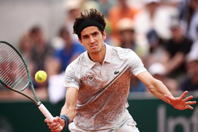France's Pierre-Hugues Herbert plays a forehand return to Brazil's Joao Fonseca during their men's singles match on day 5 of the French Open tennis tournament at the Roland-Garros Complex in Paris on May 29, 2025. (Photo by Anne-Christine POUJOULAT / AFP)