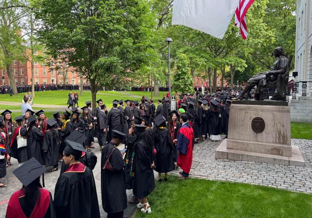 Graduates gather before the start of the commencement ceremony at Harvard University in Cambridge, Massachusetts, on May 29, 2025. US President Donald Trump is furious at Harvard for rejecting his administration's push for oversight on admissions and hiring, amid the president's claims the school is a hotbed of anti-Semitism and "woke" liberal ideology. (Photo by Eva Claire HAMBACH / AFP)