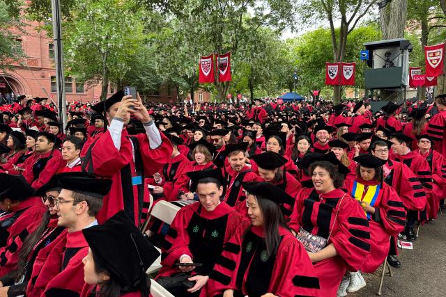 Graduates gather to attend the commencement ceremony at Harvard University in Cambridge, Massachusetts, on May 29, 2025. US President Donald Trump is furious at Harvard for rejecting his administration's push for oversight on admissions and hiring, amid the president's claims the school is a hotbed of anti-Semitism and "woke" liberal ideology. (Photo by Rick Friedman / AFP)