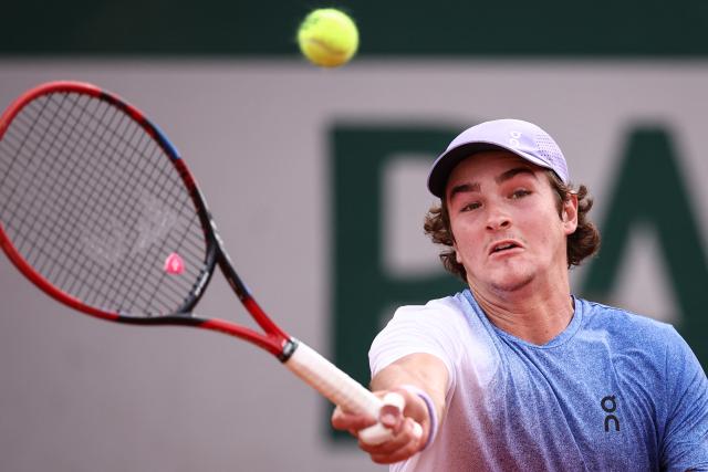Brazil's Joao Fonseca plays a forehand return to France's Pierre-Hugues Herbert during their men's singles match on day 5 of the French Open tennis tournament at the Roland-Garros Complex in Paris on May 29, 2025. (Photo by Anne-Christine POUJOULAT / AFP)