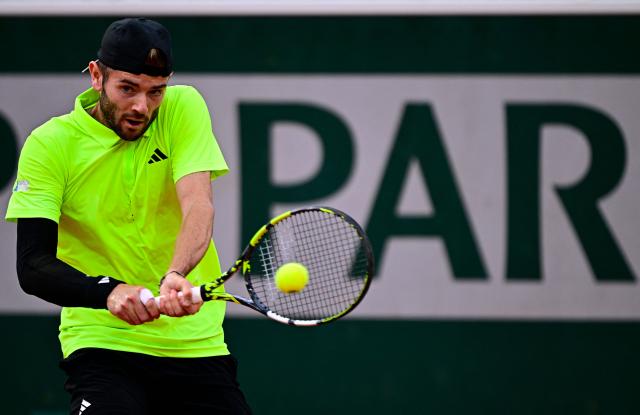 Britain's Jacob Fearnley plays a backhand return to France's Ugo Humbert during their men's singles match on day 5 of the French Open tennis tournament on Court Simonne-Mathieu at the Roland-Garros Complex in Paris on May 29, 2025. (Photo by JULIEN DE ROSA / AFP)