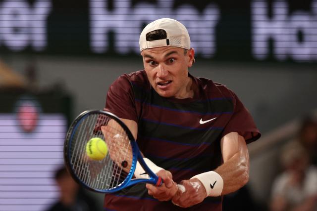 Britain's Jack Draper plays a backhand return to France's Gael Monfils during their men's singles match on day 5 of the French Open tennis tournament on Court Philippe-Chatrier at the Roland-Garros Complex in Paris on May 29, 2025. (Photo by Alain JOCARD / AFP)