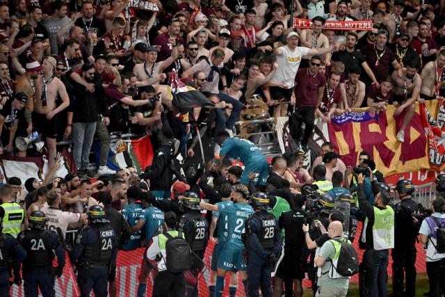 Metz team players celebrate with supporters in the stands after winning the French L1-L2 playoff second leg football match between Stade de Reims and FC Metz at Stade Auguste-Delaune in Reims, northern France on May 29, 2025. Metz moves up to Ligue 1, and Reims is relegated to Ligue 2. (Photo by FRANCOIS NASCIMBENI / AFP)