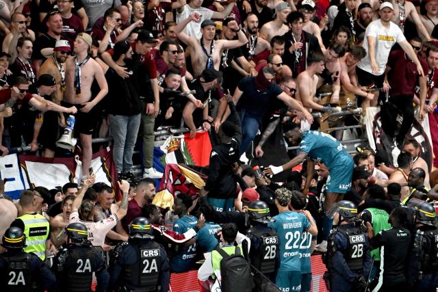 Metz team players celebrate with supporters in the stands after winning the French L1-L2 playoff second leg football match between Stade de Reims and FC Metz at Stade Auguste-Delaune in Reims, northern France on May 29, 2025. Metz moves up to Ligue 1, and Reims is relegated to Ligue 2. (Photo by FRANCOIS NASCIMBENI / AFP)