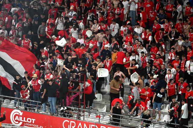 Reims supporters dismantle chairs to trow in the stands following their team's defeat in the French L1-L2 playoff second leg football match between Stade de Reims and FC Metz at Stade Auguste-Delaune in Reims, northern France on May 29, 2025. Metz moves up to Ligue 1, and Reims is relegated to Ligue 2. (Photo by FRANCOIS NASCIMBENI / AFP)