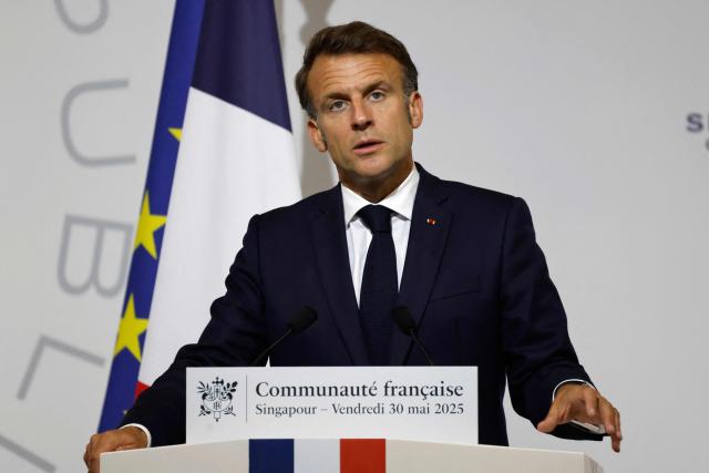 France's President Emmanuel Macron delivers an address during a reception for members of the French community at the International French School (IFS) in Singapore on May 30, 2025. (Photo by Ludovic MARIN / AFP)