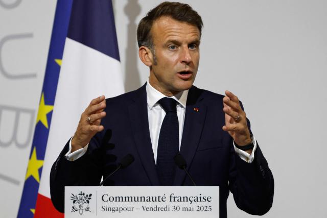 France's President Emmanuel Macron delivers an address during a reception for members of the French community at the International French School (IFS) in Singapore on May 30, 2025. (Photo by Ludovic MARIN / AFP)