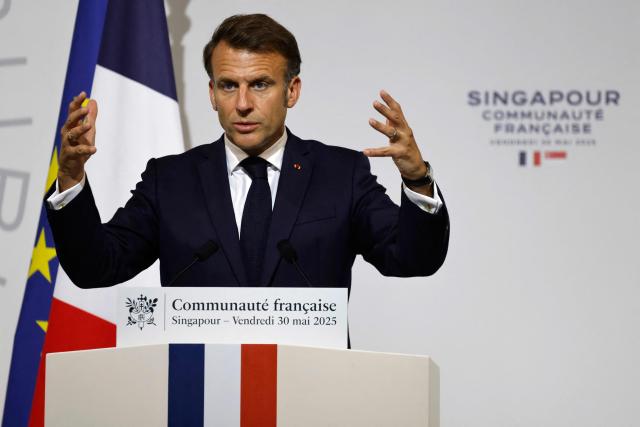 France's President Emmanuel Macron delivers an address during a reception for members of the French community at the International French School (IFS) in Singapore on May 30, 2025. (Photo by Ludovic MARIN / AFP)
