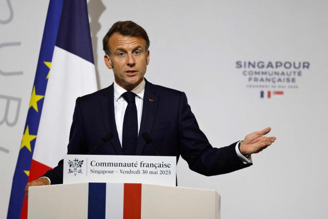 France's President Emmanuel Macron delivers an address during a reception for members of the French community at the International French School (IFS) in Singapore on May 30, 2025. (Photo by Ludovic MARIN / AFP)