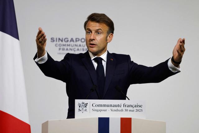 France's President Emmanuel Macron delivers an address during a reception for members of the French community at the International French School (IFS) in Singapore on May 30, 2025. (Photo by Ludovic MARIN / AFP)