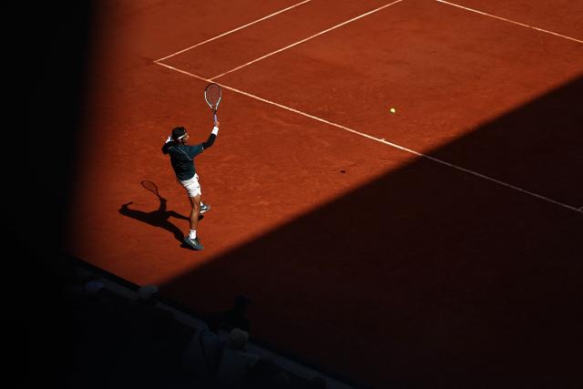Italy's Lorenzo Musetti plays a forehand return to Argentina's Mariano Navone during their men's singles match on day 6 of the French Open tennis tournament on Court Suzanne-Lenglen at the Roland-Garros Complex in Paris on May 30, 2025. (Photo by Anne-Christine POUJOULAT / AFP)