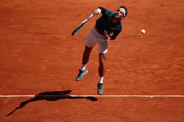 Italy's Lorenzo Musetti serves to Argentina's Mariano Navone during their men's singles match on day 6 of the French Open tennis tournament on Court Suzanne-Lenglen at the Roland-Garros Complex in Paris on May 30, 2025. (Photo by Anne-Christine POUJOULAT / AFP)