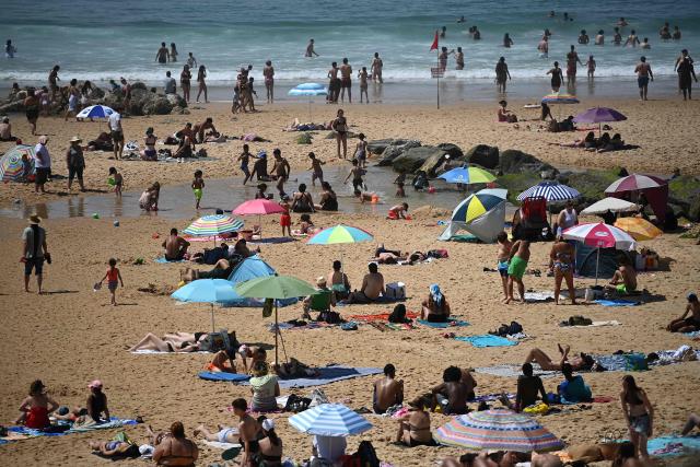 Sunbathers enjoy the beach on a warm afternoon along the Atlantic Ocean in Lacanau, south-western France on May 30, 2025. (Photo by Christophe ARCHAMBAULT / AFP)
