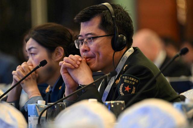 Chinese military officials attend the Shangri-La Dialogue Summit in Singapore on May 31, 2025. (Photo by MOHD RASFAN / AFP)