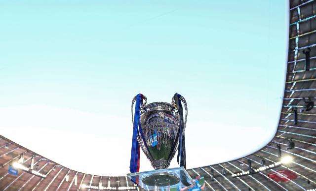 The trophy is displayed on the pitch prior to the UEFA Champions League final football match between Paris Saint-Germain (PSG) and Inter Milan at the Munich Football Arena in Munich, southern Germany, on May 31, 2025. (Photo by FRANCK FIFE / AFP)