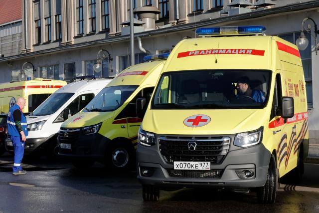 A Russian medic stands next to ambulances parked at Kievsky railway station in Moscow on June 1, 2025, as they wait for the arrival of injured passengers following a bridge collapse in the Bryansk region. At least seven people were killed late on May 31, 2025 and dozens injured after a bridge collapsed onto a railway in a Russian region bordering Ukraine, officials said, in an incident the railway operator blamed on "illegal interference". (Photo by TATYANA MAKEYEVA / AFP)