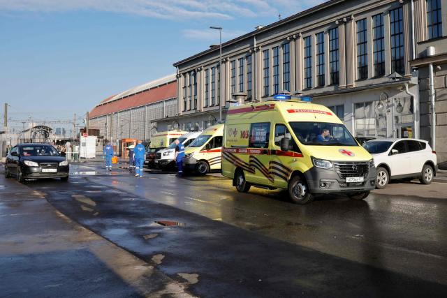 Russian medics stand next to ambulances parked at Kievsky railway station in Moscow on June 1, 2025, as they wait for the arrival of injured passengers following a bridge collapse in the Bryansk region. At least seven people were killed late on May 31, 2025 and dozens injured after a bridge collapsed onto a railway in a Russian region bordering Ukraine, officials said, in an incident the railway operator blamed on "illegal interference". (Photo by TATYANA MAKEYEVA / AFP)