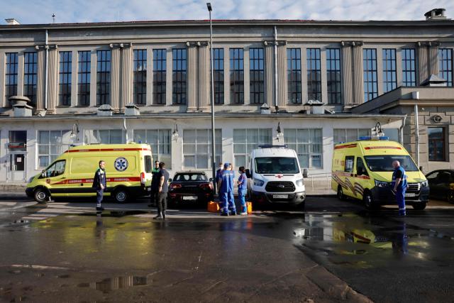 Russian medics stand next to ambulances parked at Kievsky railway station in Moscow on June 1, 2025, as they wait for the arrival of injured passengers following a bridge collapse in the Bryansk region. At least seven people were killed late on May 31, 2025 and dozens injured after a bridge collapsed onto a railway in a Russian region bordering Ukraine, officials said, in an incident the railway operator blamed on "illegal interference". (Photo by TATYANA MAKEYEVA / AFP)