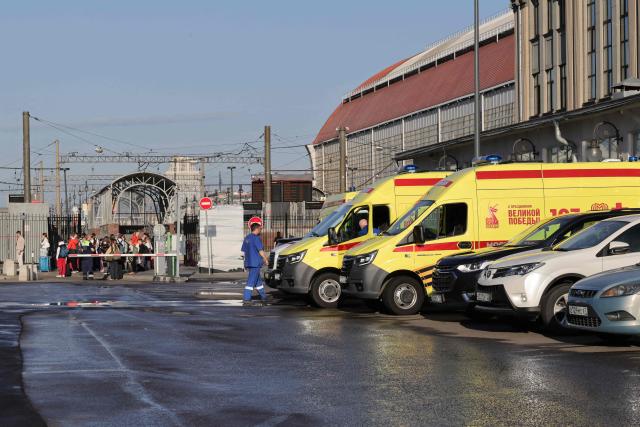 A Russian medic stands next to ambulances parked at Kievsky railway station in Moscow on June 1, 2025, as they wait for the arrival of injured passengers following a bridge collapse in the Bryansk region. At least seven people were killed late on May 31, 2025 and dozens injured after a bridge collapsed onto a railway in a Russian region bordering Ukraine, officials said, in an incident the railway operator blamed on "illegal interference". (Photo by TATYANA MAKEYEVA / AFP)