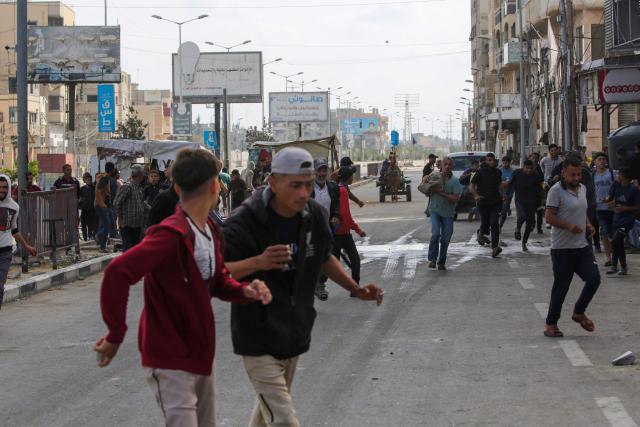 Palestinians react on a road in the area of an aid distribution point near the so-called "Netzarim checkpoint", in the central Gaza Strip, on June 1, 2025, amid the war between Israel and the Palestinian Hamas militant movement. (Photo by Eyad BABA / AFP)