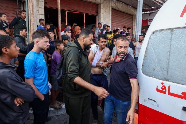 Palestinian rescuers arrive in an ambulance to evacuate injured people after an Israeli drone reportedly opened fire on civilian gatherings near an aid distribution point not far from the so-called "Netzarim checkpoint", in the central Gaza Strip, on June 1, 2025, at Bureij camp, amid the war between Israel and the Palestinian Hamas militant movement. (Photo by Eyad BABA / AFP)