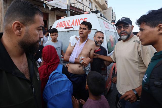 Palestinian rescuers arrive in an ambulance to evacuate injured people after an Israeli drone reportedly opened fire on civilian gatherings near an aid distribution point not far from the so-called "Netzarim checkpoint", in the central Gaza Strip, on June 1, 2025. (Photo by Eyad BABA / AFP)