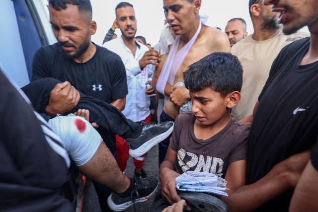 Palestinian rescuers evacuate injured people in an ambulance after an Israeli drone reportedly opened fire on civilian gatherings near an aid distribution point not far from the so-called "Netzarim checkpoint", in the central Gaza Strip, on June 1, 2025, at Bureij camp, amid the war between Israel and the Palestinian Hamas militant movement. (Photo by Eyad BABA / AFP)