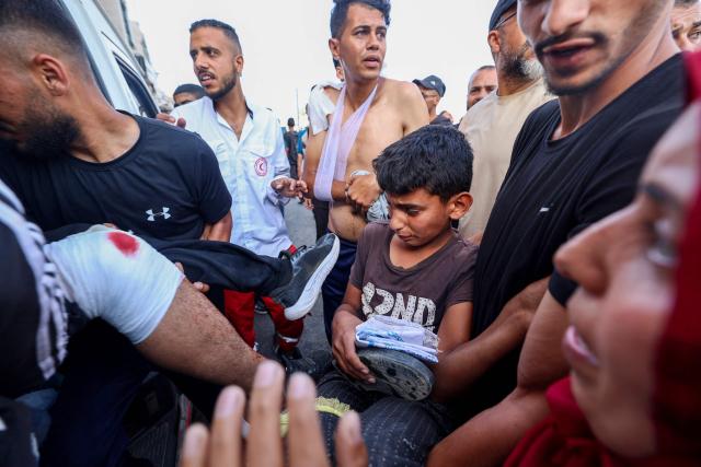 Palestinian rescuers evacuate injured people in an ambulance after an Israeli drone reportedly opened fire on civilian gatherings near an aid distribution point not far from the so-called "Netzarim checkpoint", in the central Gaza Strip, on June 1, 2025, at Bureij camp, amid the war between Israel and the Palestinian Hamas militant movement. (Photo by Eyad BABA / AFP)