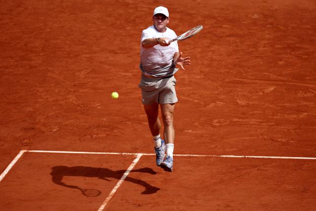 US Tommy Paul plays a forehand return to Australia's Alexei Popyrin during their men's singles match on day 8 of the French Open tennis tournament on Court Suzanne-Lenglen at the Roland-Garros Complex in Paris on June 1, 2025. (Photo by Anne-Christine POUJOULAT / AFP)