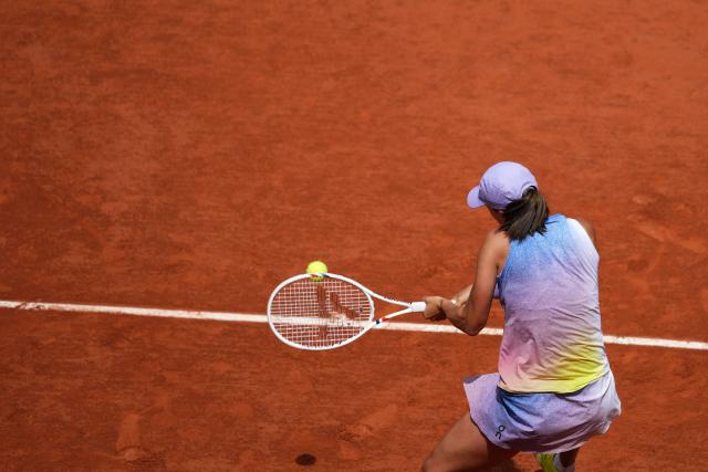Poland's Iga Swiatek plays a backhand return to Kazakhstan's Elena Rybakina during their women's singles match on day 8 of the French Open tennis tournament on Court Philippe-Chatrier at the Roland-Garros Complex in Paris on June 1, 2025. (Photo by Dimitar DILKOFF / AFP)