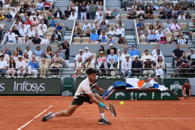 Spain's Carlos Alcaraz hits a half-volley to US Ben Shelton during their men's singles match on day 8 of the French Open tennis tournament on Court Philippe-Chatrier at the Roland-Garros Complex in Paris on June 1, 2025. (Photo by Dimitar DILKOFF / AFP)