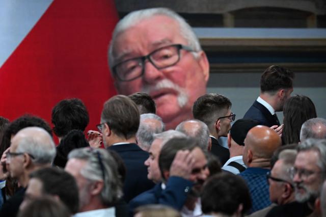 Former president of Poland Lech Walesa is seen on a giant screen as supporters of Rafal Trzaskowski, Warsaw's Mayor and member of ruling centrist Civic Coalition party, react as exit polls were announced on tv during their election night event at the the National Museum of Ethnography in Warsaw, Poland, during the second round of the presidential elections on June 1, 2025. Poles voted in a tight presidential election runoff that will have major implications for the country's role in Europe, and for abortion and LGBTQ rights. Opinion polls have predicted an extremely close race with nationalist historian Karol Nawrocki and pro-EU Warsaw Mayor Rafal Trzaskowski neck and neck ahead of the vote. (Photo by Sergei GAPON / AFP)