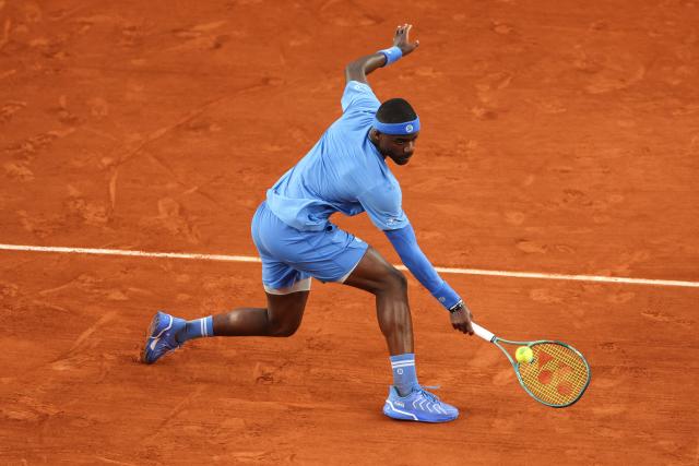 US Frances Tiafoe plays a backhand return to Germany's Daniel Altmaier during their men's singles match on day 8 of the French Open tennis tournament on Court Suzanne-Lenglen at the Roland-Garros Complex in Paris on June 1, 2025. (Photo by ALAIN JOCARD / AFP)