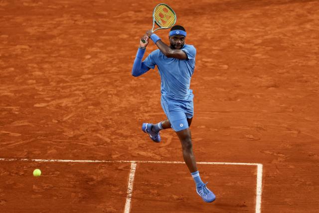 US Frances Tiafoe plays a backhand return to Germany's Daniel Altmaier during their men's singles match on day 8 of the French Open tennis tournament on Court Suzanne-Lenglen at the Roland-Garros Complex in Paris on June 1, 2025. (Photo by ALAIN JOCARD / AFP)