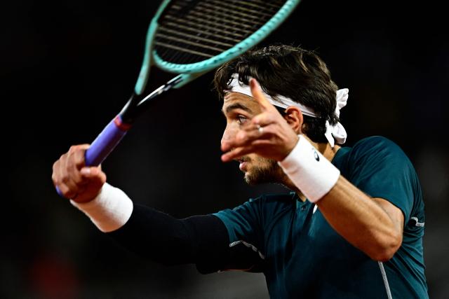 Italy's Lorenzo Musetti plays against Denmark's Holger Rune during their men's singles match on day 8 of the French Open tennis tournament on Court Philippe-Chatrier at the Roland-Garros Complex in Paris on June 1, 2025. (Photo by JULIEN DE ROSA / AFP)