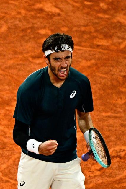 Italy's Lorenzo Musetti reacts after winning a set during his men's singles match against Denmark's Holger Rune on day 8 of the French Open tennis tournament on Court Philippe-Chatrier at the Roland-Garros Complex in Paris on June 1, 2025. (Photo by JULIEN DE ROSA / AFP)